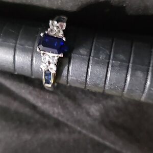 Sapphire Center in 14 CT white gold  and inlaid Sapphire down both sides. Size 6